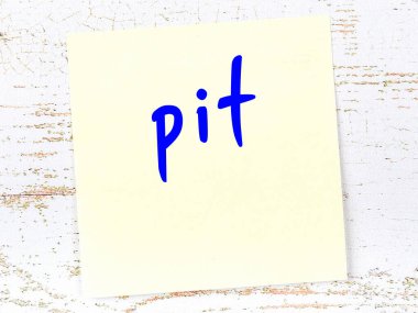 Çukur hakkında hatırlatma kavramı. Tahta duvarda üzerinde yazı olan sarı yapışkan kağıt.