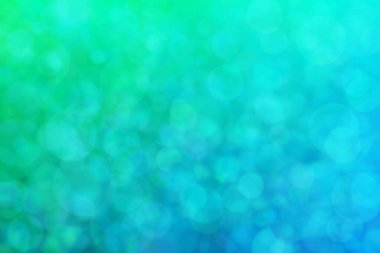 Çember şekilli bokeh benekli yeşil ve mavi soyutlanmış arkaplan