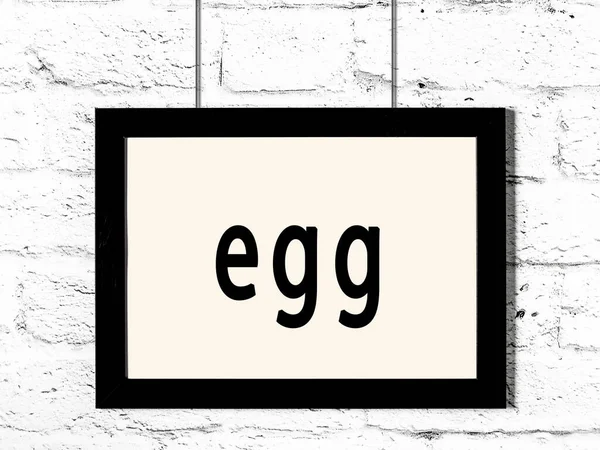 Black Wooden Frame Inscription Egg Hanging White Brick Wall — Stock Photo, Image