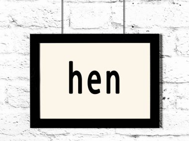 Siyah ahşap çerçeve, beyaz tuğla duvarda yazılı tavuk asılı. 