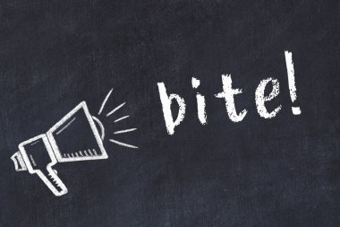 Hoparlörün tebeşir çizimi ve siyah masaya el yazısıyla yazılmış bir yazı ısırığı.