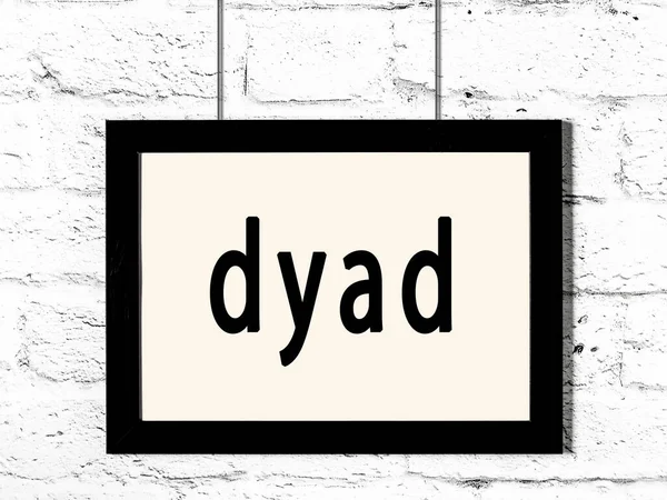 Black Wooden Frame Inscription Dyad Hanging White Brick Wall — Stock Photo, Image