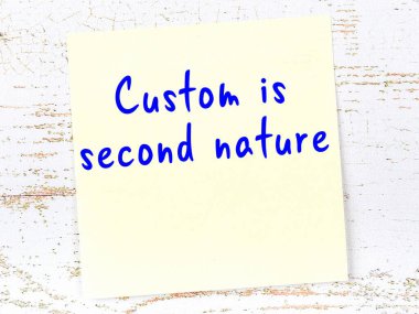 Tahta duvarda el yazısı motivasyon alıntısı olan sarı yapışkan not