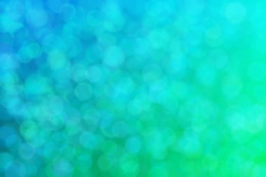 Çember şekilli bokeh benekli yeşil ve mavi soyutlanmış arkaplan