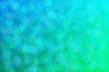Çember şekilli bokeh benekli yeşil ve mavi soyutlanmış arkaplan