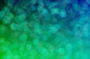 Yeşil ve mavi renklerin geçişleriyle harmonik gradyan ve çember şeklinde bokeh.