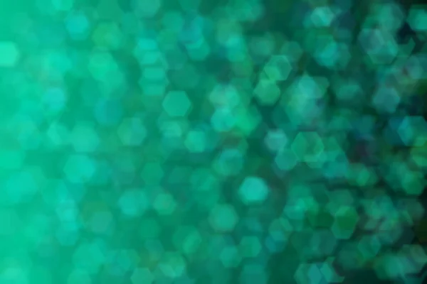 Harmonic gradient with transitions of green and blue colors and hexagon shaped bokeh.