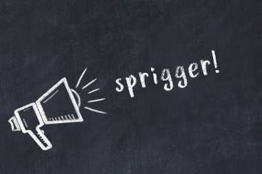 Hoparlörün tebeşir çizimi ve siyah masanın üzerine el yazısıyla yazılmış yazması sprigger.