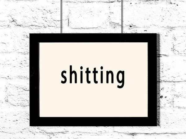 Black Wooden Frame Inscription Shitting Hanging White Brick Wall — Stockfoto