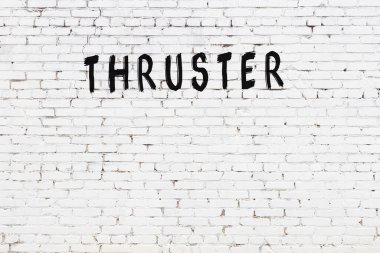 Üzerinde siyah boya bulunan beyaz tuğladan bir duvar.