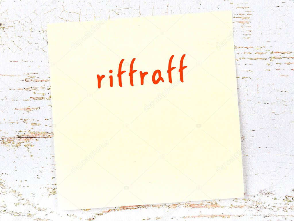 Concept of reminder about riffraff. Yellow sticky sheet of paper on wooden wall with inscription
