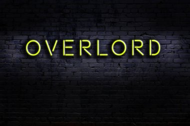 Tuğla duvara yazılı neon levhası. Gece görünümü