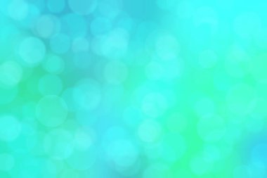 Çember şeklindeki bokeh noktalarıyla mavi ve yeşil soyut odaklanmış arkaplan