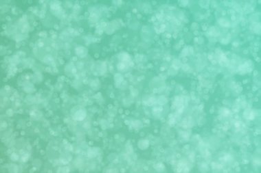 Aquamarine soyutlanmış çember şeklindeki bokeh noktalarıyla odaklanmış arkaplan