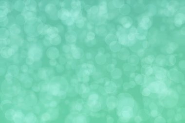 Aquamarine soyutlanmış çember şeklindeki bokeh noktalarıyla odaklanmış arkaplan
