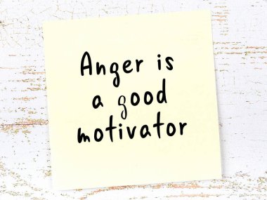 Sarı yapışkan not, ahşap duvarda el yazısıyla yazılmış zekice bir alıntıyla.