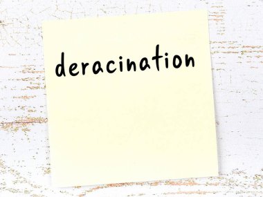 Tahta duvardaki sarı yapışkan notta elle yazılmış derakinasyon var.