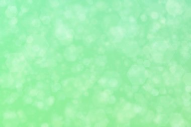 açık yeşil soyut odaklanmış arkaplan altıgen şekilli bokeh benekleri ile