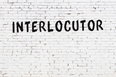 Beyaz tuğla duvara siyah boya ile yazılmış bir yazıcı..