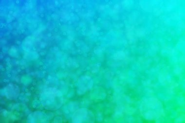 Çember şekilli bokeh benekli yeşil ve mavi soyutlanmış arkaplan