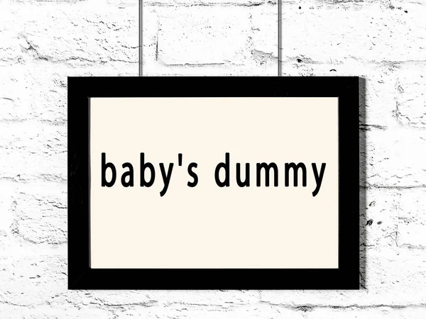 Black Wooden Frame Inscription Baby Dummy Hanging White Brick Wall — Stock Photo, Image