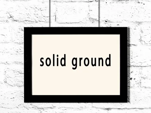 Black Wooden Frame Inscription Solid Ground Hanging White Brick Wall — Stock Photo, Image