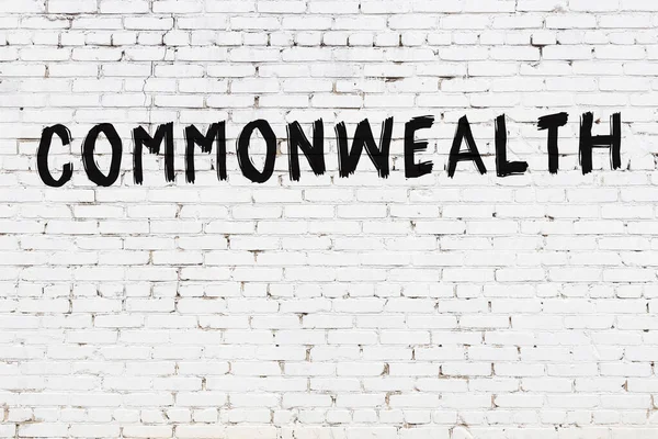 Commonwealth Inscripción Escrita Con Pintura Negra Pared Ladrillo Blanco —  Fotos de Stock