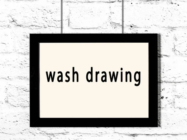 Black Wooden Frame Inscription Wash Drawing Hanging White Brick Wall — Stock Photo, Image