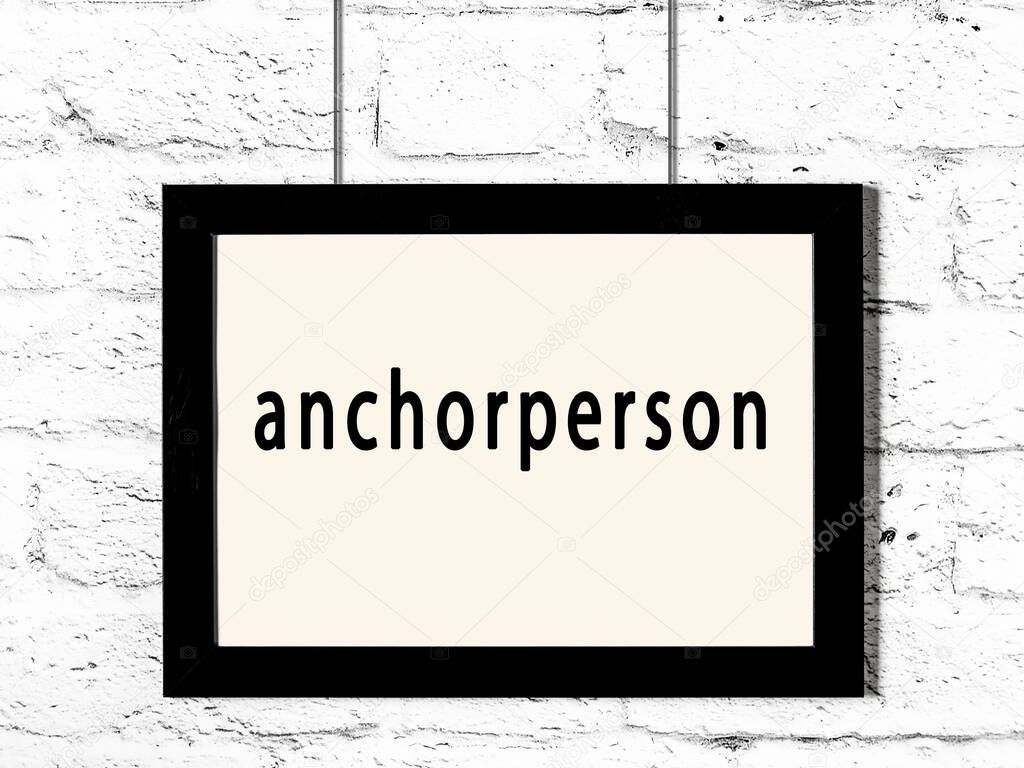 Black wooden frame with inscription anchorperson hanging on white brick wall 