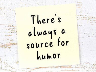 Tahta duvarda asılı sarı yapışkan nota elle yazılmış bilgece bir alıntı.