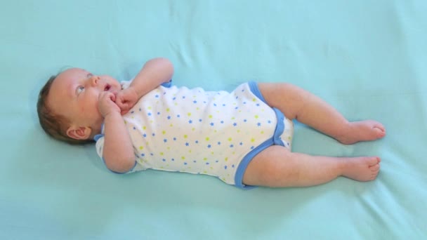 Newborn Child Relaxing In Bed — Stock Video