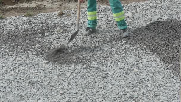 Trabajador con pala en obras de construcción — Vídeos de Stock