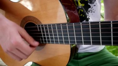 Genç adam bir gitar Solo yavaş oynamaya