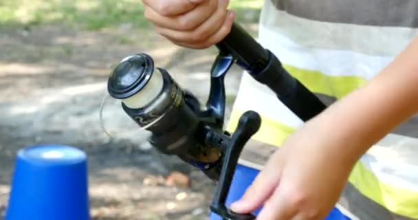 Boy Fishing With Spinning On The River — Stock Video