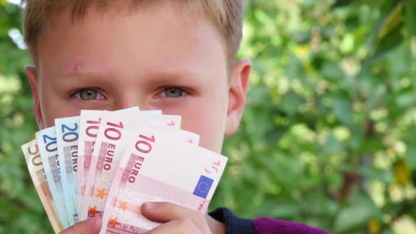 Boy Smelling Euro Notes — Stock Video