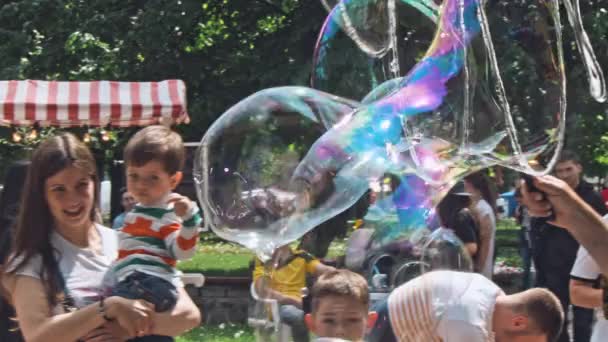 Burbujas pequeñas y grandes en el festival al aire libre en el centro de la ciudad — Vídeo de stock