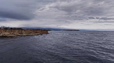 Bu İHA görüntülerinde Bulgaristan 'ın engebeli kıyı şeridi sergileniyor. Kara bulutlar tepemize çökerken dalgalar kayalıklara çarpar ve dramatik bir atmosfer yaratır..