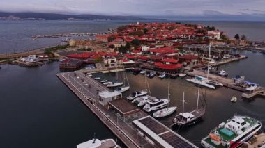 Bulgaristan 'ın Nesebar kentinde çarpıcı bir hava manzarası. Drone perspektifi marinanın tekneler ve şehrin büyüleyici mimarisi ile dolu olduğunu gösteriyor..