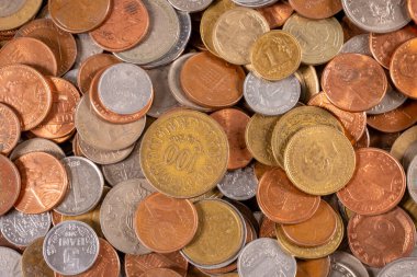 Değişik boyutlarda ve renklerde sikkeler bir yüzeye saçılmıştır. Bazıları parlak, bazıları ise yıpranmış. Bozuk paralar birbirine karışır ve değerleri değişir..