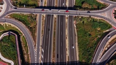 Açık bir günde İspanya 'da otoyolda arabalar sürülür. Sahne, farklı yönlere hareket eden birçok şerit ve aracı gösteriyor..