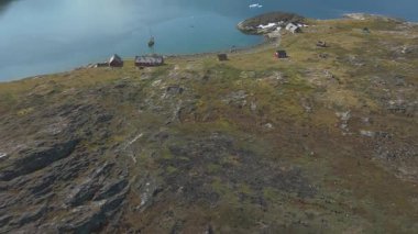 Çorak topraktan turkuaz denize, dağınık buza, kıyı evlerine ve parlak yaz berraklığına doğru ilerleyen hava hareketleri..