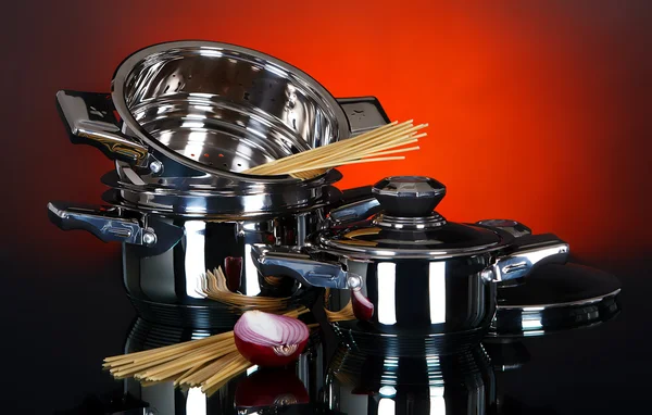 A set of pots and pans on a dark background — Stock Photo, Image