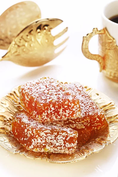 Pieces of marmalade in coconut flakes. Sweets with coconut.Traditional turkish sweets.