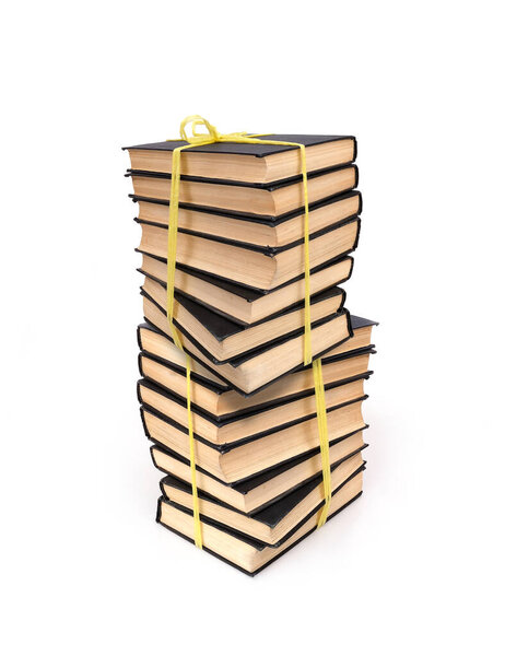 Stack of books in black covers with white sheets isolated on a white background