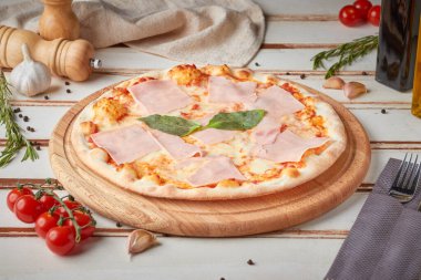 Dilimlenmiş pizza, sos ve otlar, ahşap beyaz arka plan