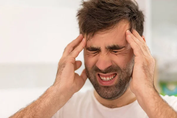 Close up foto de homem barbudo com dor de cabeça pela manhã. — Fotografia de Stock