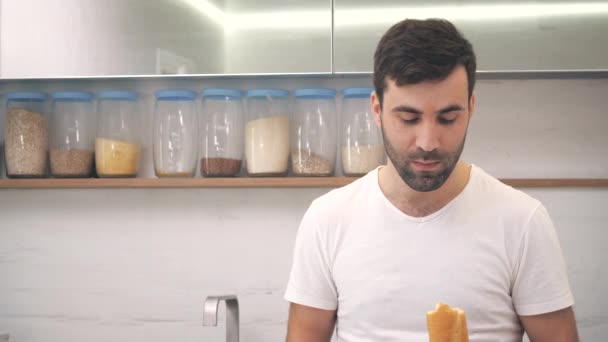 4k vídeo de homem com fome barbudo mordendo pão fresco. — Vídeo de Stock