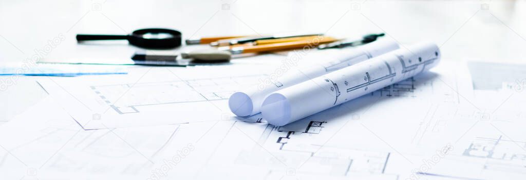 Photo of architectural project, blueprints and engineering tools.