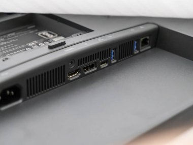 Modern bir bilgisayar monitörünün arka panelinin çok yönlü dijital, iş ve multimedya bağlantıları için gerekli olan gücü, HDMI, USB ve LAN portlarını gösteren yakın plan