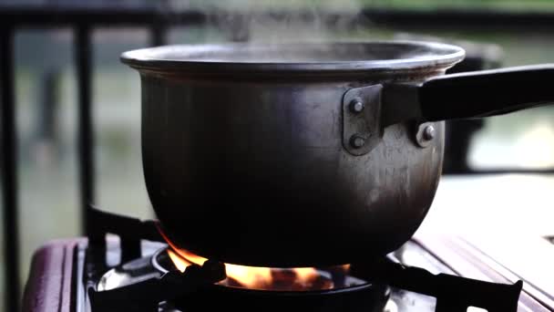 Boiling water in pan. Cooking pot on stove with water and steam